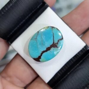 Large 16.53 carat natural Egyptian turquoise (Feroza) oval cabochon featuring a brilliant sky-blue body with a prominent, deep reddish-brown branching matrix.