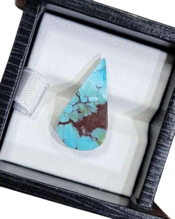 Vibrant 5.60 carat natural Egyptian turquoise (Feroza) pear cabochon displaying a bright sky-blue surface with a dense, dark chocolate-brown iron stone matrix.