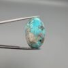An exceptionally large 45.93-carat natural Iranian Turquoise (Feroza) from Kerman City, featuring a high-domed oval cabochon cut with a vivid blue base and dense metallic pyrite inclusions.