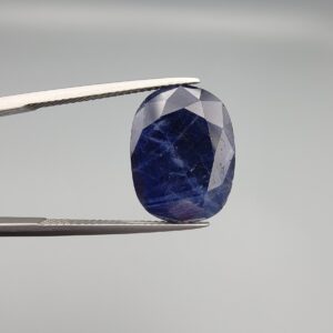 A 12.80-carat natural deep blue Sapphire from Afghanistan, featuring an elegant oval facet cut, displayed in a professional jeweler's gemstone box.