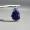An 8.24-carat natural blue Sapphire from Afghanistan, featuring a professional pear-shaped facet cut, displayed in a gemstone box.