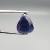 A 13.18-carat natural deep blue Sapphire from Afghanistan, master-faceted into a pear shape and displayed in a professional gemstone box.