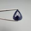 A 13.18-carat natural deep blue Sapphire from Afghanistan, master-faceted into a pear shape and displayed in a professional gemstone box.