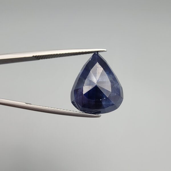 A 13.18-carat natural deep blue Sapphire from Afghanistan, master-faceted into a pear shape and displayed in a professional gemstone box.
