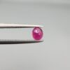 ​A 0.47-carat natural red Ruby (Yaqoot) from Kabul, Afghanistan, featuring an oval faceted cut with rich red color and natural inclusions, held in jeweler's tweezers.