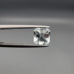 ​A 2.15-carat natural Shigar Valley Aquamarine (Beruj) gemstone with an octagon emerald cut, featuring clear sky-blue color and beautiful natural inclusions, held in jeweler's tweezers.