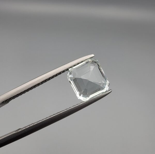​A 2.15-carat natural Shigar Valley Aquamarine (Beruj) gemstone with an octagon emerald cut, featuring clear sky-blue color and beautiful natural inclusions, held in jeweler's tweezers.