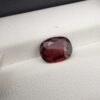 A 3.26-carat natural oval-cut Madagascar Garnet featuring a rich deep red color and high-clarity facets, displayed in a gemstone case.