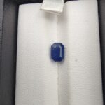 A 1.92-carat natural Ceylon Blue Sapphire featuring a vivid blue color and an octagon faceted cut, presented in a white jeweler's box.