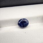 ​A 3.58-carat natural Ceylon blue sapphire with a vivid blue color and oval faceted cut, professionally displayed in a white jeweler's box.