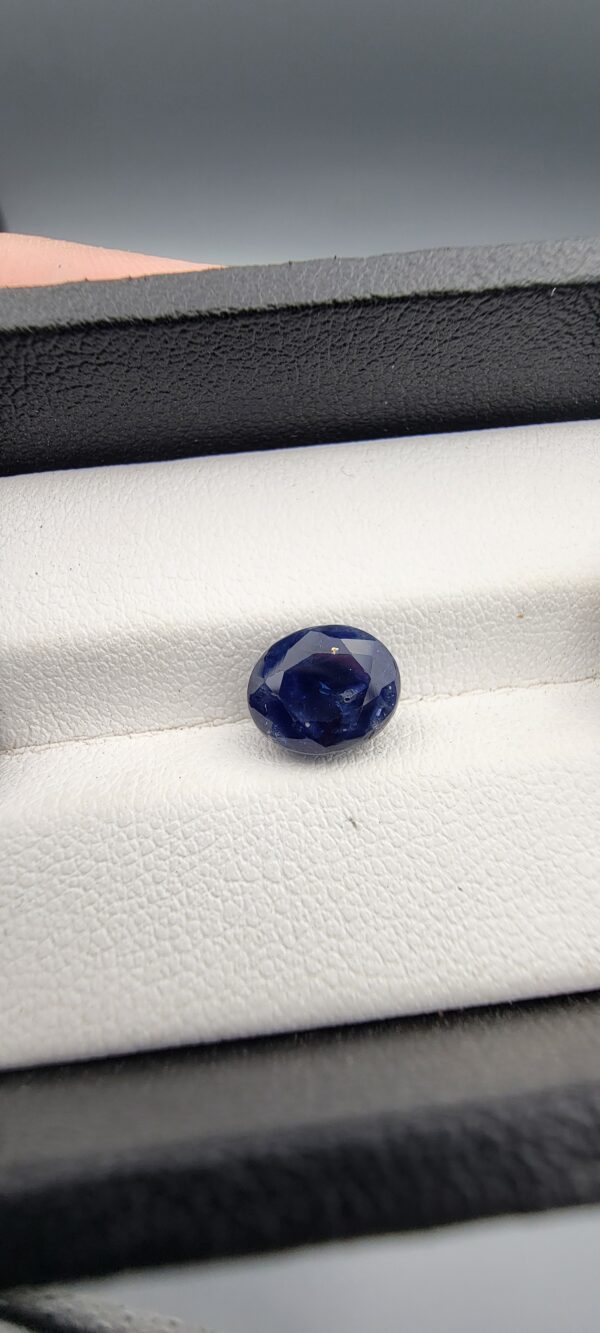 ​A 3.58-carat natural Ceylon blue sapphire with a vivid blue color and oval faceted cut, professionally displayed in a white jeweler's box.