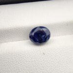 ​A 3.58-carat natural Ceylon blue sapphire with a vivid blue color and oval faceted cut, professionally displayed in a white jeweler's box.