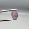 ​A 2.96-carat natural Ceylon purple sapphire with a transparent violet-purple color and oval faceted cut, shown in a white jeweler's box under professional lighting.