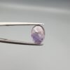 ​A 2.96-carat natural Ceylon purple sapphire with a transparent violet-purple color and oval faceted cut, shown in a white jeweler's box under professional lighting.