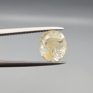 ​A 4.39-carat natural Ceylon yellow sapphire with transparent clarity and golden internal inclusions, featuring an oval faceted cut, displayed in a white jeweler's box.