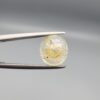 ​A 4.39-carat natural Ceylon yellow sapphire with transparent clarity and golden internal inclusions, featuring an oval faceted cut, displayed in a white jeweler's box.