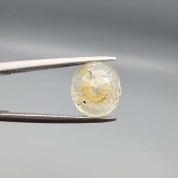 ​A 4.39-carat natural Ceylon yellow sapphire with transparent clarity and golden internal inclusions, featuring an oval faceted cut, displayed in a white jeweler's box.