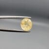 ​A 1.84-carat natural Ceylon yellow sapphire with an oval faceted cut and high transparency, displayed in a white jeweler's box.
