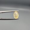A 2.27-carat natural Ceylon yellow sapphire with an oval faceted cut and high transparency, professionally displayed in a jeweler's box.