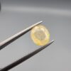 ​A 1.84-carat natural Ceylon yellow sapphire featuring an oval faceted cut and exceptional transparency, professionally displayed in a white jeweler's box.