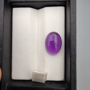 ​A 5.07-carat natural Brazilian amethyst with a rich purple color and faceted cut, accompanied by a GGI Laboratory certificate of authenticity.