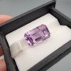 A massive 15.18-carat natural Brazilian amethyst with a soft light purple lavender color and precision faceted cut, displayed in a white jeweler's box.