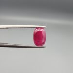 A 2.92-carat natural Mozambique ruby with a vivid Pigeon's Blood red color and faceted cut, professionally displayed in a jeweler's box.