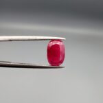 A 2.92-carat natural Mozambique ruby with a vivid Pigeon's Blood red color and faceted cut, professionally displayed in a jeweler's box.