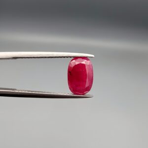 A 2.92-carat natural Mozambique ruby with a vivid Pigeon's Blood red color and faceted cut, professionally displayed in a jeweler's box.