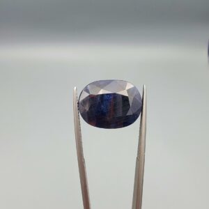 A massive 16.66-carat natural blue sapphire from Afghanistan with an oval faceted cut and deep royal blue color, professionally displayed in a white jeweler's box.