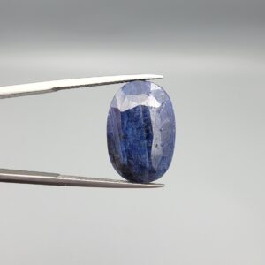 An extraordinary 25.07-carat natural blue sapphire from Afghanistan, featuring an oval faceted cut and deep blue saturation, displayed in a professional jeweler's box.
