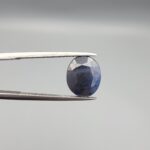 ​A 3.82-carat natural blue sapphire from Afghanistan with an oval faceted cut and deep royal blue color, presented in a professional white jeweler's box.