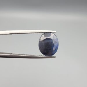 ​A 3.82-carat natural blue sapphire from Afghanistan with an oval faceted cut and deep royal blue color, presented in a professional white jeweler's box.