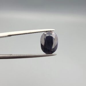 A 3.85-carat natural blue sapphire from Afghanistan with an oval faceted cut and deep royal blue color, presented in a professional white jeweler's box.