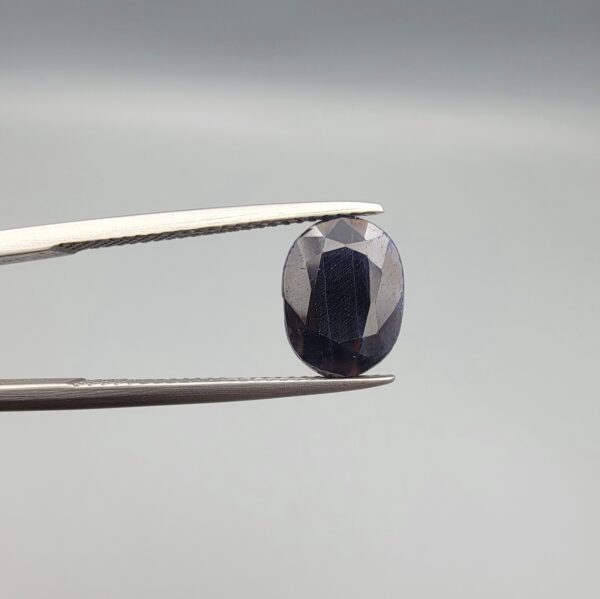 A 3.85-carat natural blue sapphire from Afghanistan with an oval faceted cut and deep royal blue color, presented in a professional white jeweler's box.