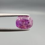 A rare 1.85-carat unheated natural purple sapphire (Khooni Neelam) from Ceylon, Sri Lanka, featuring a masterfully faceted oval cut and deep violet-purple saturation, presented in a professional white jeweler's box.