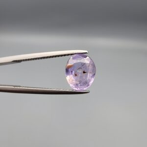 A rare 1.98-carat unheated natural purple sapphire (Khooni Neelam) from Ceylon, Sri Lanka, featuring a masterfully faceted oval cut and deep royal violet saturation, presented in a professional white jeweler's box.