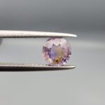 A rare 1.25-carat unheated natural purple sapphire (Khooni Neelam) from Ceylon, Sri Lanka, featuring a masterfully faceted round brilliant cut and deep royal violet saturation, presented in a professional jeweler's box.