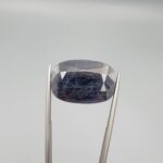 An extraordinary 26.56-carat natural blue sapphire from Afghanistan with an oval faceted cut and deep royal blue color, professionally displayed in a white jeweler's box.