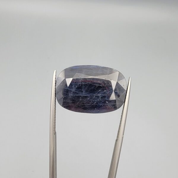 An extraordinary 26.56-carat natural blue sapphire from Afghanistan with an oval faceted cut and deep royal blue color, professionally displayed in a white jeweler's box.