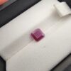 A 1.41-carat natural red ruby from Mozambique with an octagon emerald cut, showcasing high clarity and vibrant red brilliance, displayed in a professional jeweler's box.