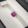 A 1.41-carat natural red ruby from Mozambique with an octagon emerald cut, showcasing high clarity and vibrant red brilliance, displayed in a professional jeweler's box.