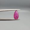A 1.14-carat natural red ruby from Mozambique in a pear faceted cut, showing authentic natural surface pits and rich red color, displayed in a professional jeweler's box.