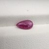 A 1.14-carat natural red ruby from Mozambique in a pear faceted cut, showing authentic natural surface pits and rich red color, displayed in a professional jeweler's box.