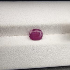 A 1.38-carat natural red ruby from Mozambique with a cushion faceted cut, showcasing intense red color and high clarity.