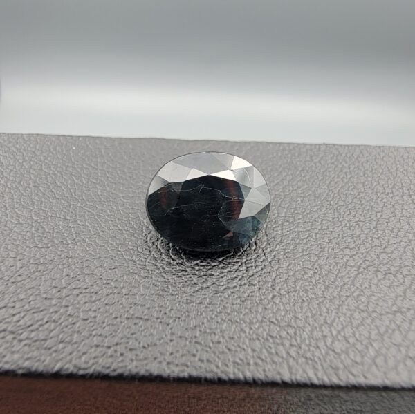A 4.44-carat natural blue sapphire from Kanchanaburi, Thailand, featuring a classic oval faceted cut and rich royal blue color, displayed in a professional jeweler's box.