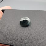 A 4.46-carat natural blue sapphire from Kanchanaburi, Thailand, featuring a deep royal blue color and a classic oval faceted cut, presented in a professional jeweler's box