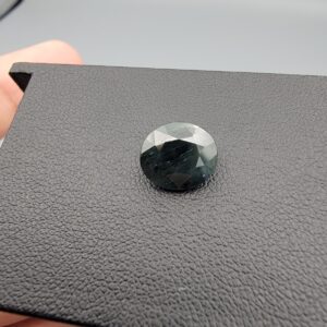 A 4.46-carat natural blue sapphire from Kanchanaburi, Thailand, featuring a deep royal blue color and a classic oval faceted cut, presented in a professional jeweler's box