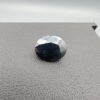 A 4.90-carat natural blue sapphire from Kanchanaburi, Thailand, featuring a classic oval faceted cut and a deep midnight blue color, displayed in a professional jeweler's box.