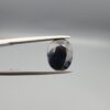 A 4.90-carat natural blue sapphire from Kanchanaburi, Thailand, featuring a classic oval faceted cut and a deep midnight blue color, displayed in a professional jeweler's box.